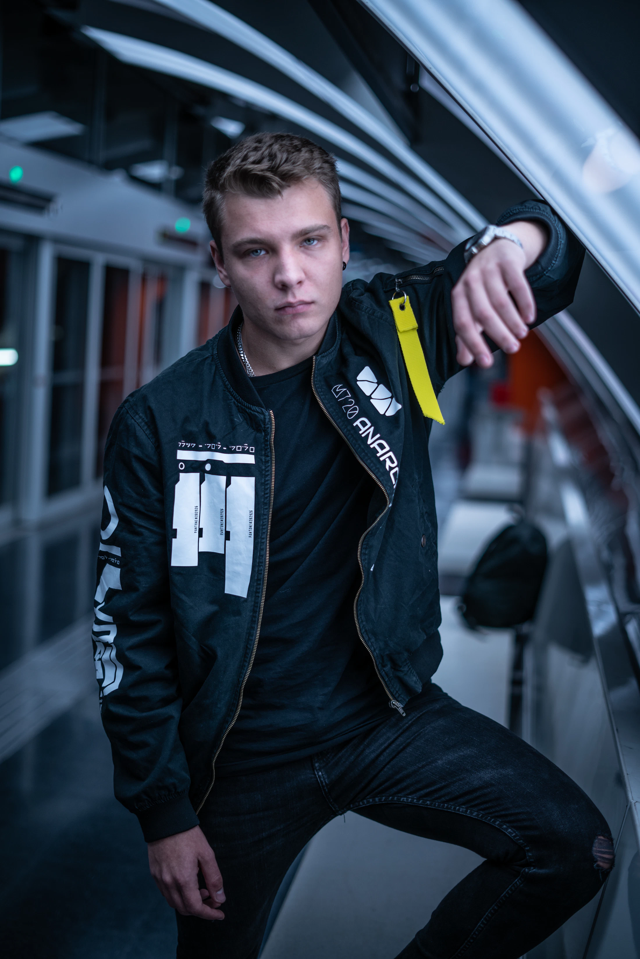 Model wearing a black bomber jacket in an urban setting