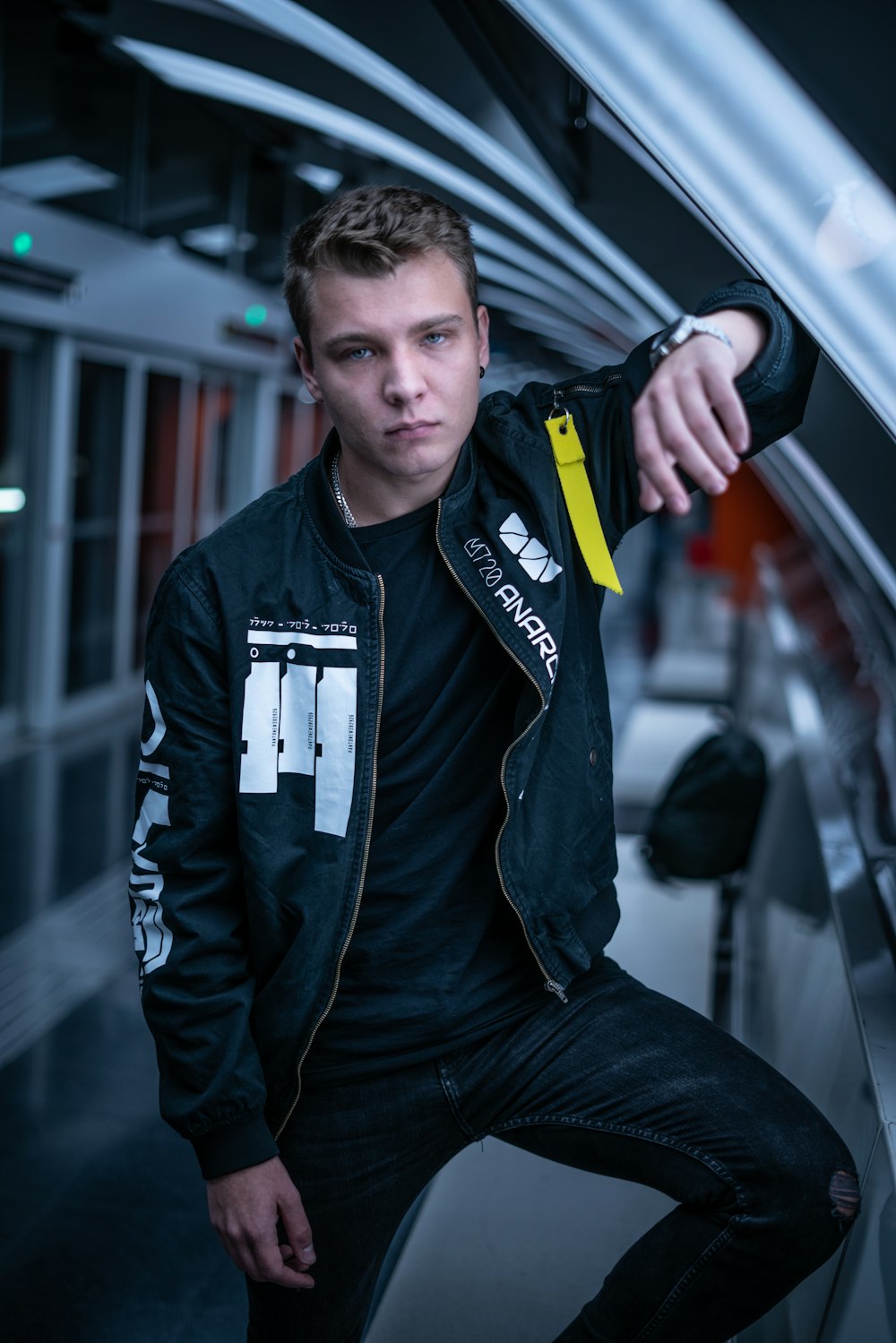 shallow focus photo of man in black full-zip bomber jacket