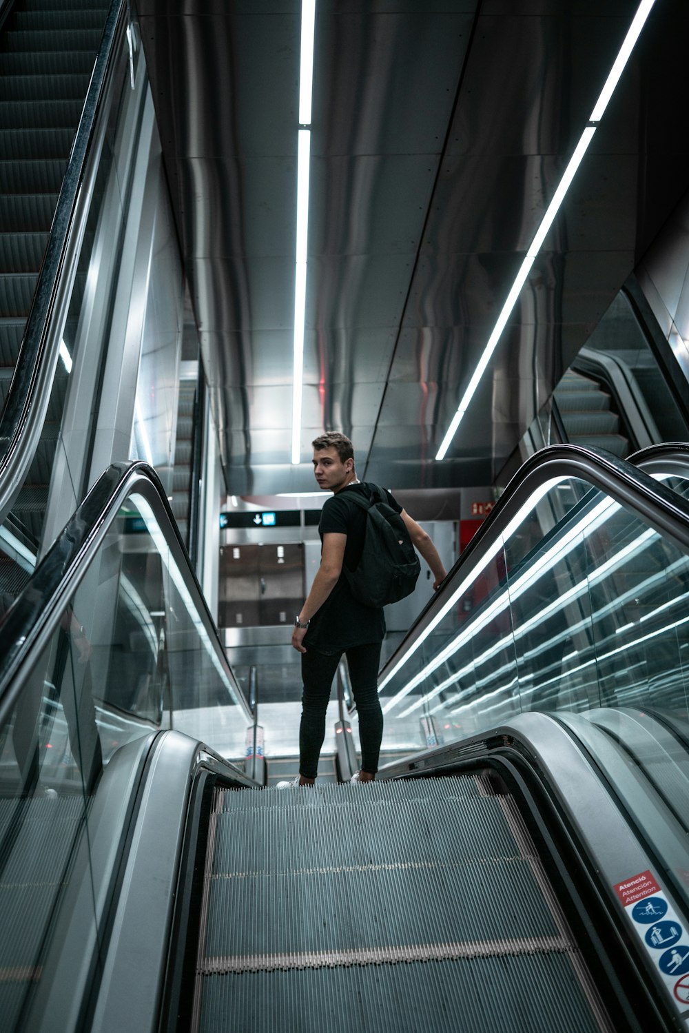 a man riding an escalator down a set of stairs