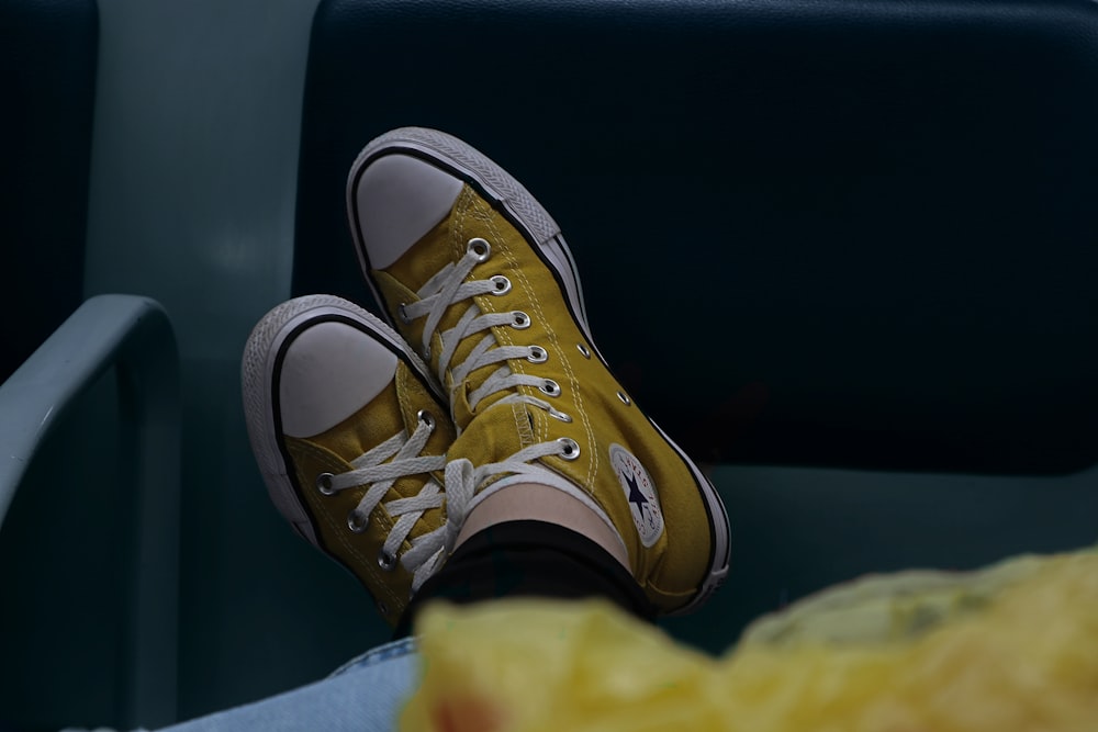 pair of yellow Converse high-top sneakers