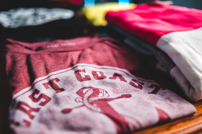 focus photography of several folded clothes