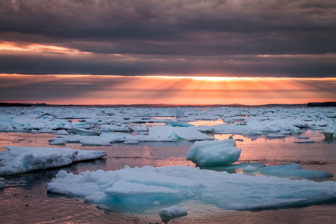 body of water under cloudy sky