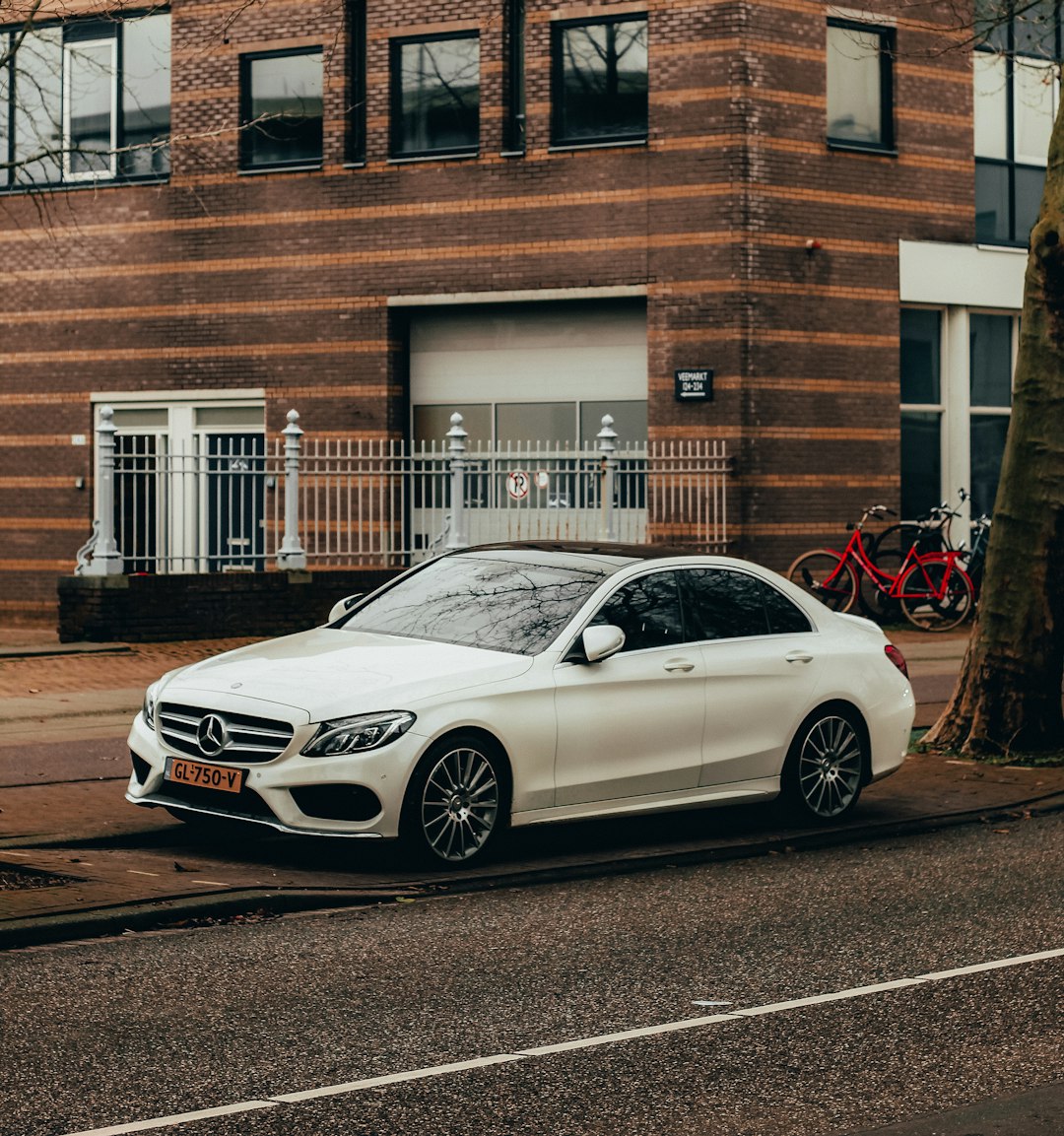 white Mercedes-Benz sedan on road