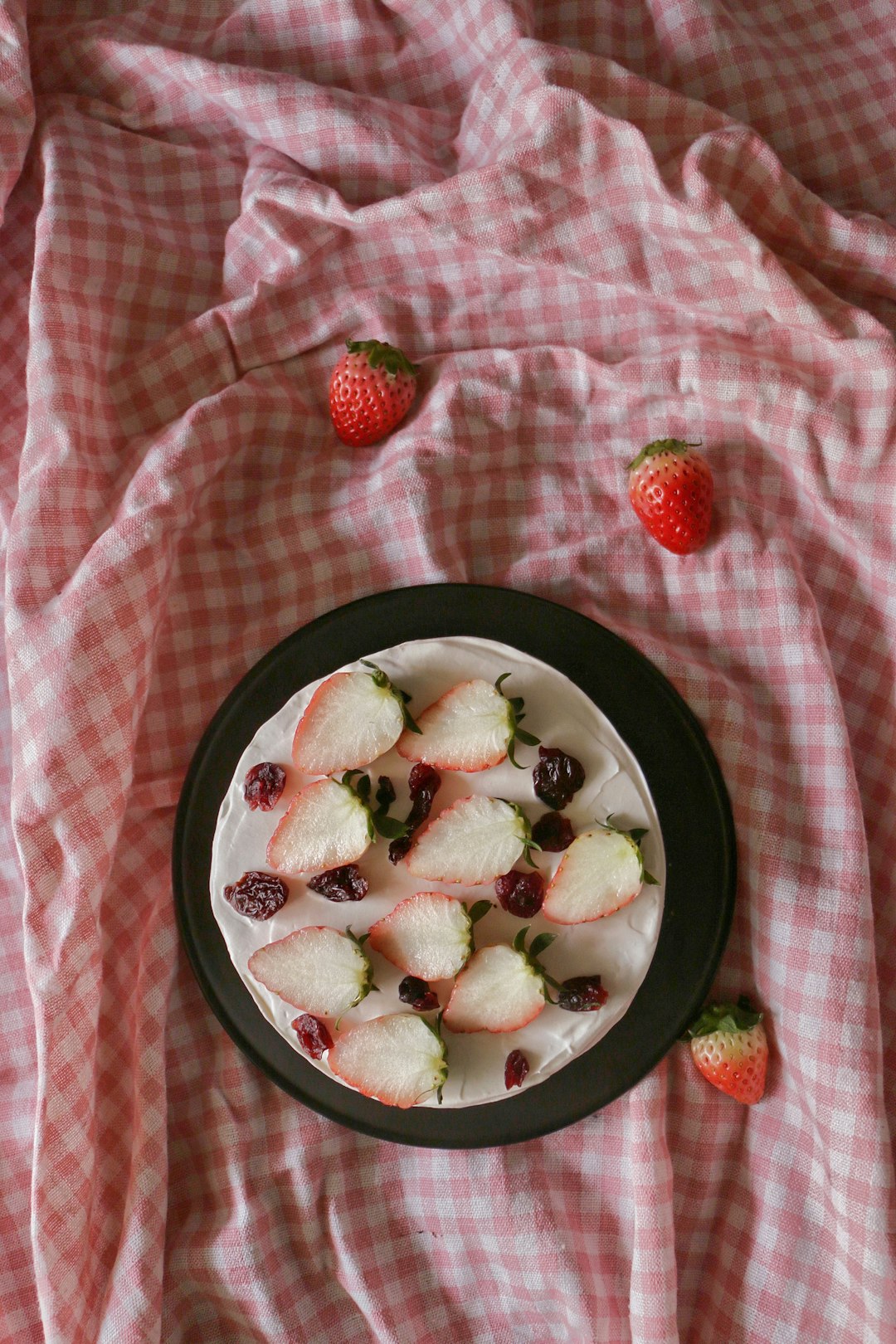 flat-lay photography of a round cake with strawberry toppings