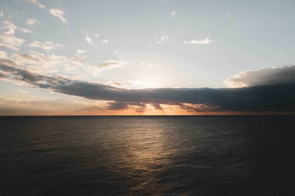 ocean under cloudy sky