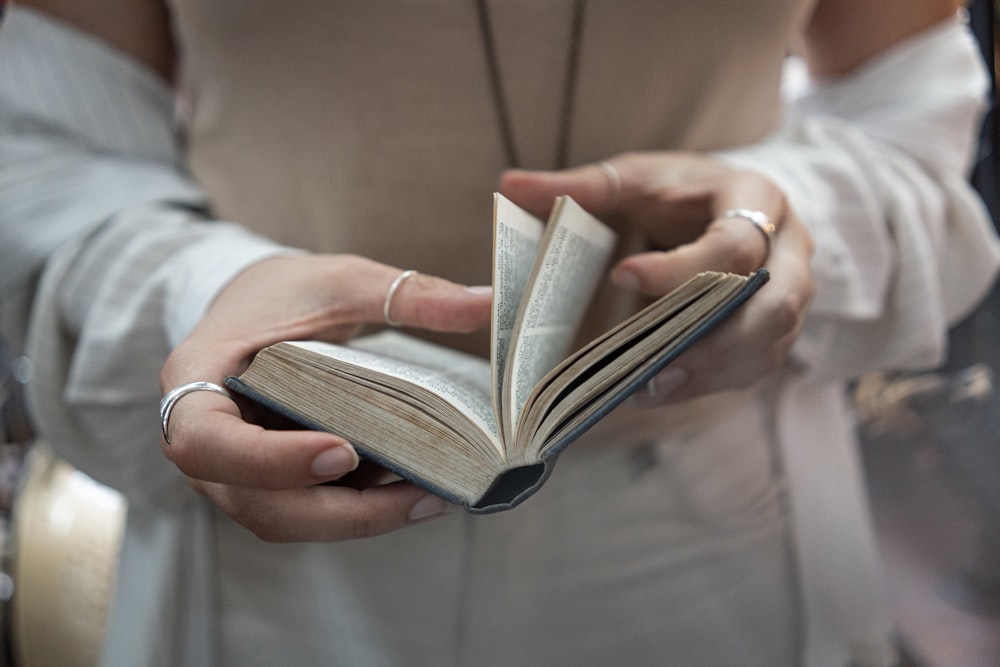 woman flipping over pages of a book