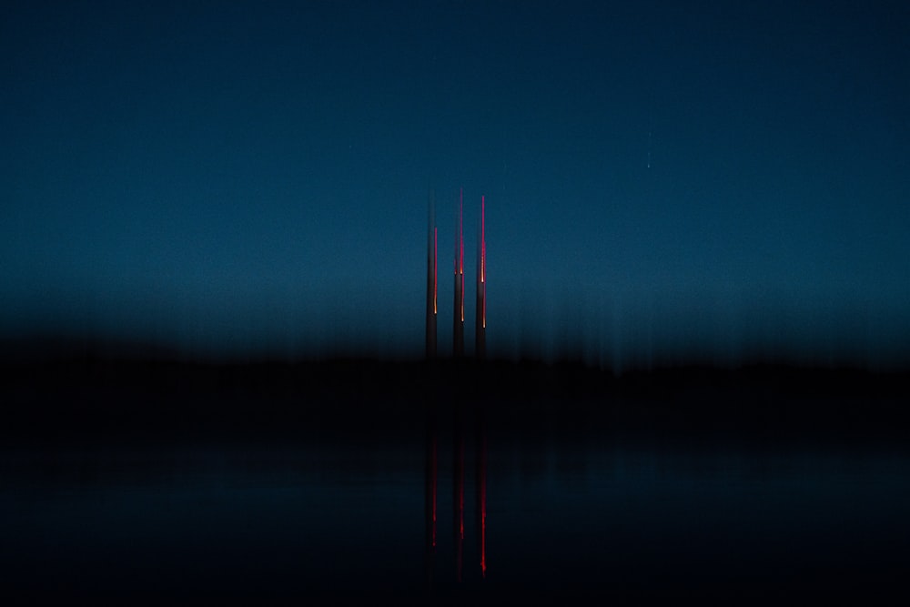 a very tall tower sitting in the middle of a lake