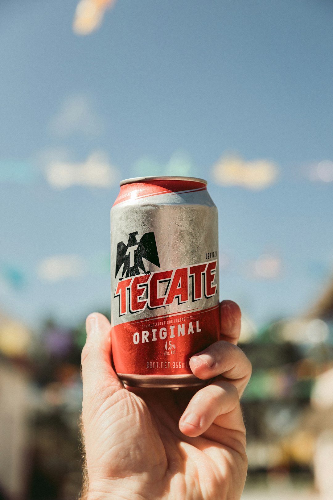 shallow focus photo of gray and red Tecate can