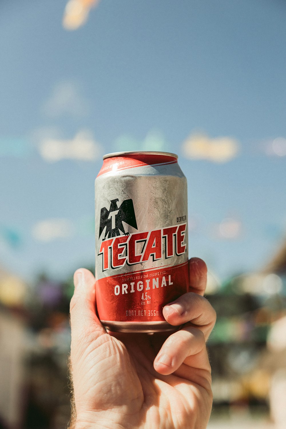 shallow focus photo of gray and red Tecate can