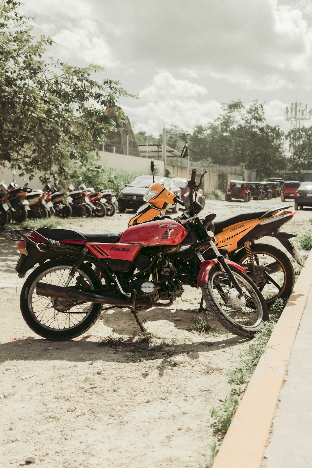 two yellow and red motorcycles in a parking lot