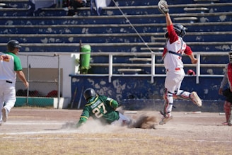 An action shot of a player sliding into home plate.