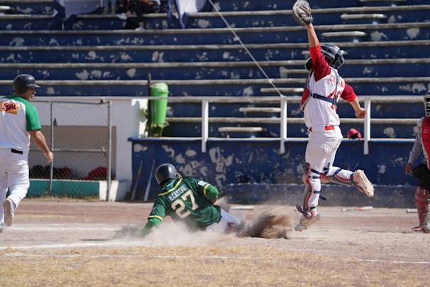 An action shot of a player sliding into home plate.