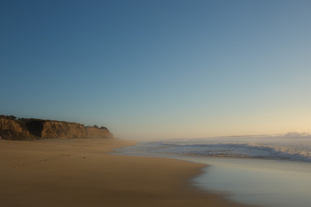 brown seashore under clear blue sky