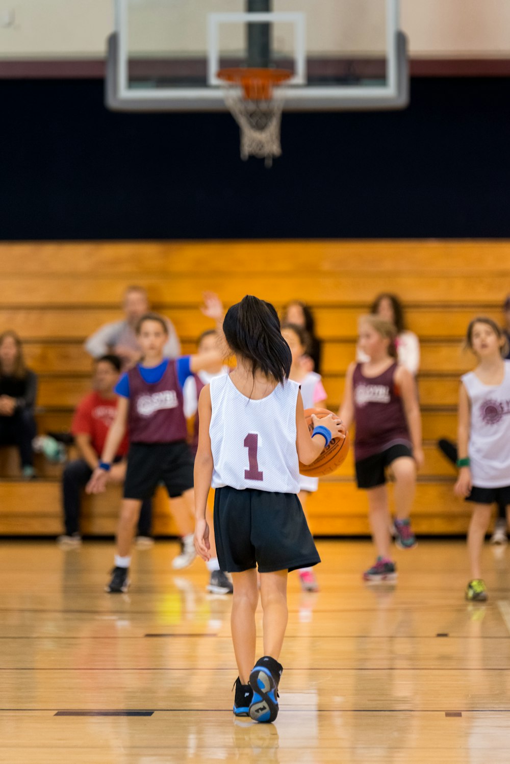 a group of young people playing a game of basketball