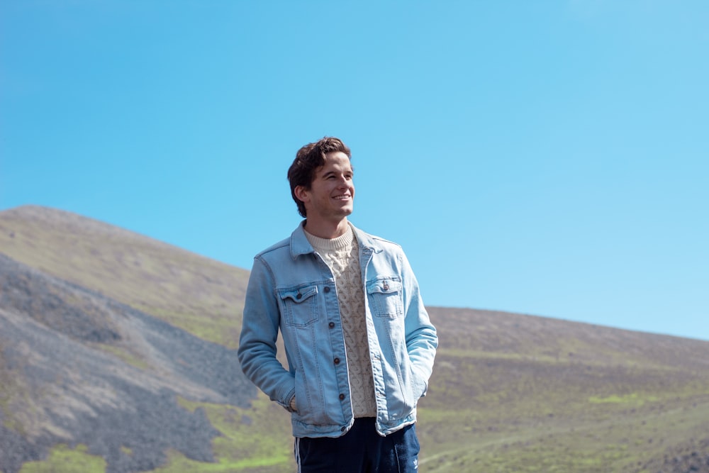 shallow focus photo of man in blue denim button-up jacket