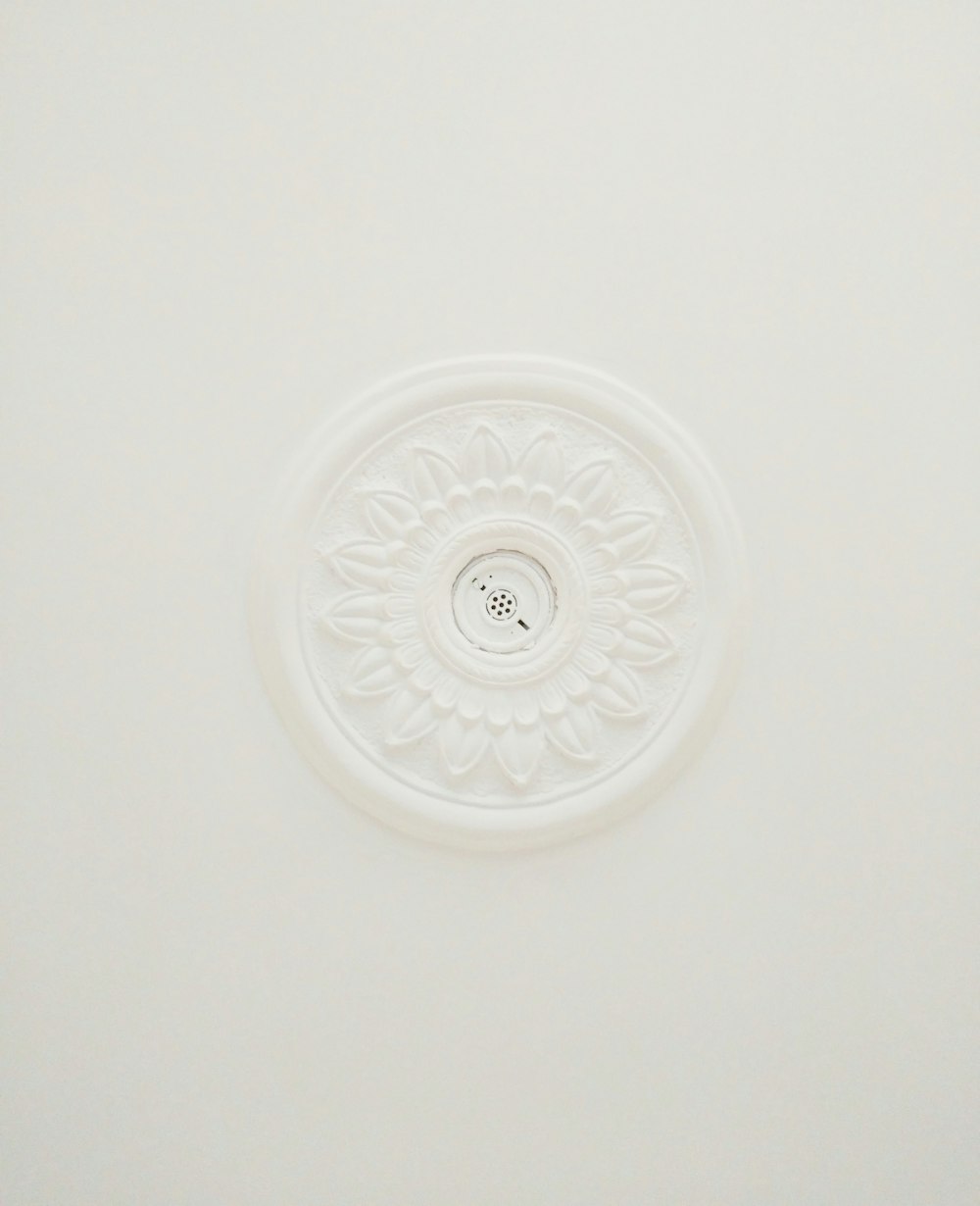 a white ceiling with a circular design on the ceiling
