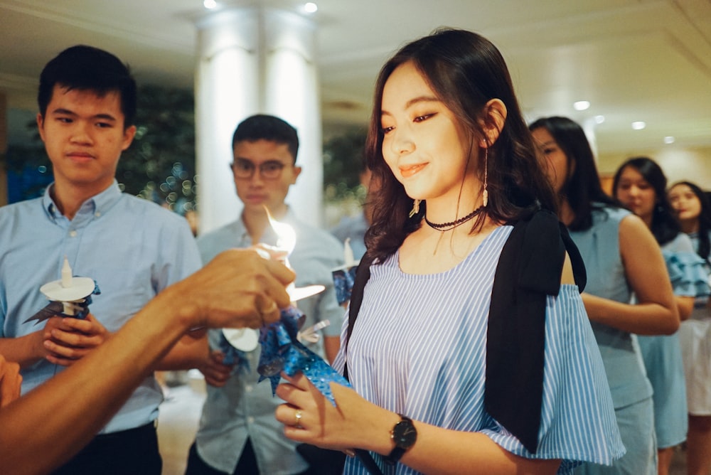 men and women wearing blue tops standing in line