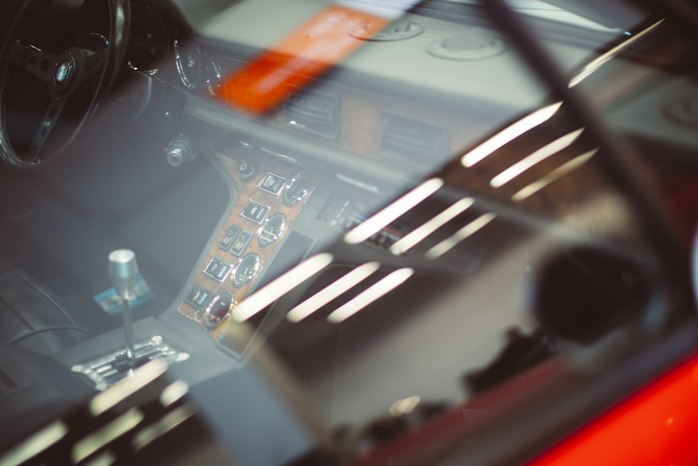 a car dashboard with a steering wheel and dashboard lights