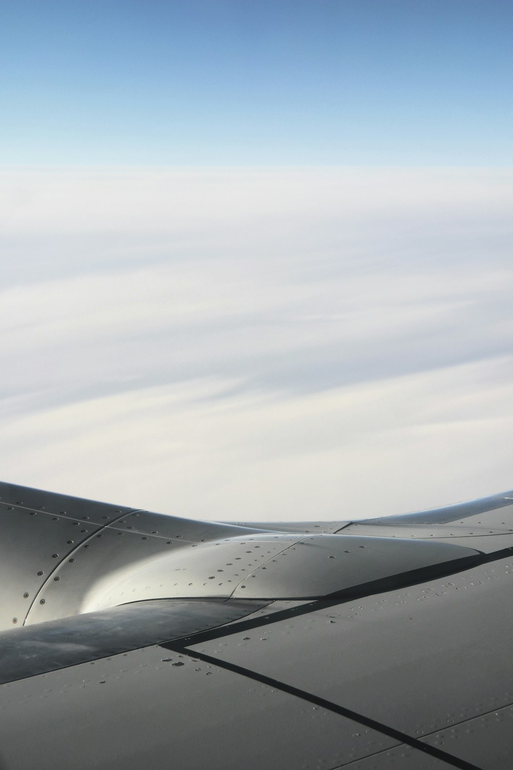 a view of the wing of an airplane in the sky