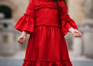 girl wearing red long-sleeved dress