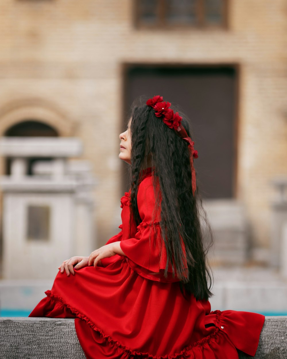 girl sitting on concrete railing