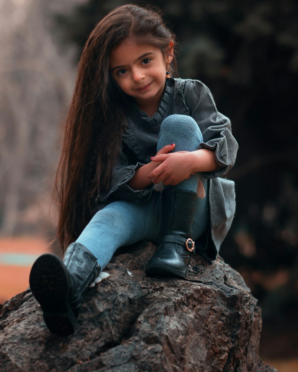 girl sitting on rock