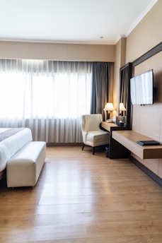 Sunlit boutique hotel room with soft neutral tones and natural textures.