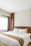 black sconce beside white bed