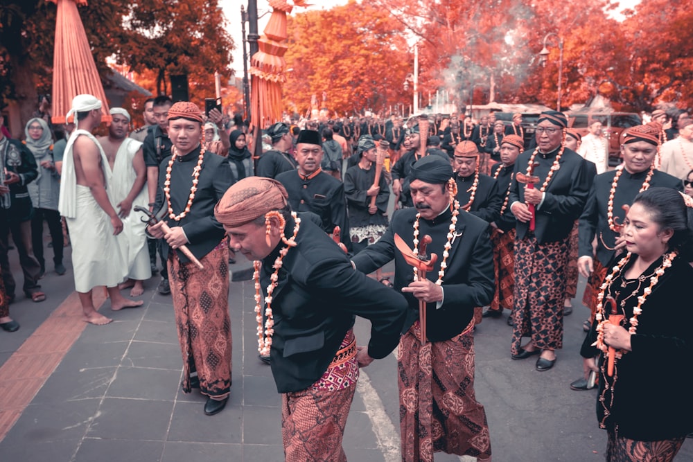 men standing near red trees