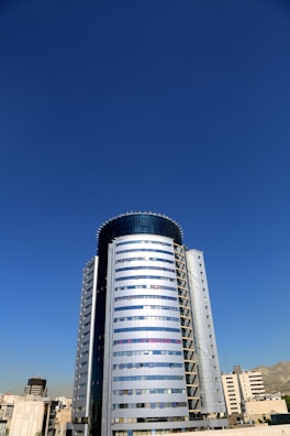 Exterior view of Bihar Trade Tower showcasing its towering glass facade against a clear sky.