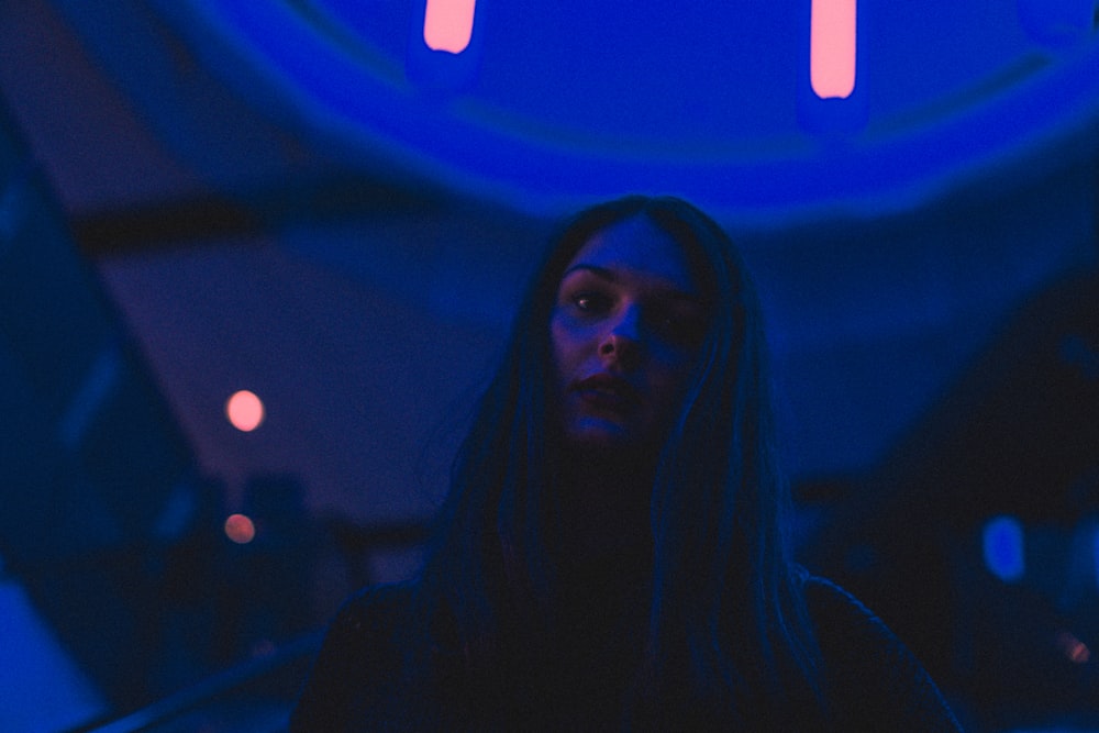 woman inside a blue-lighted room