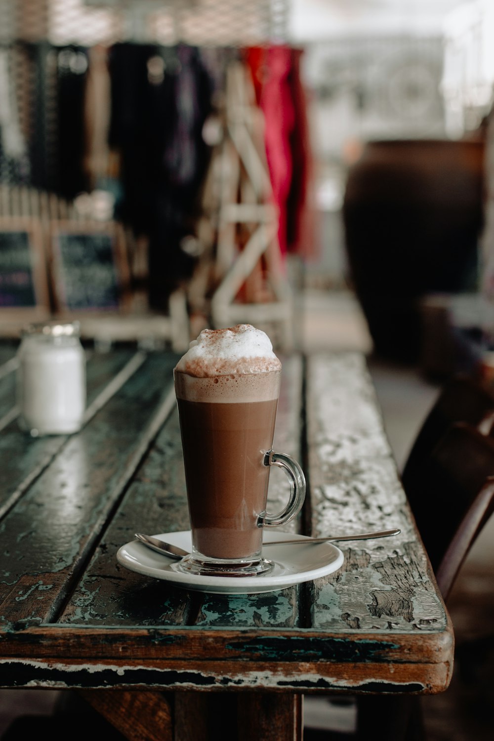 shallow focus photo of chocolate drink in clear glass mug