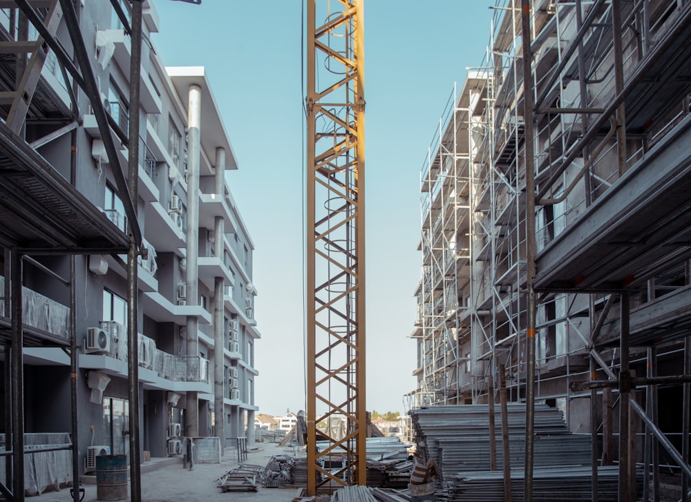 yellow tower crane between structure