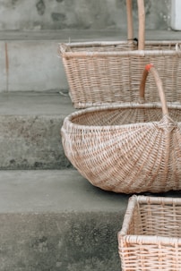 three brown wicker baskets on stairs