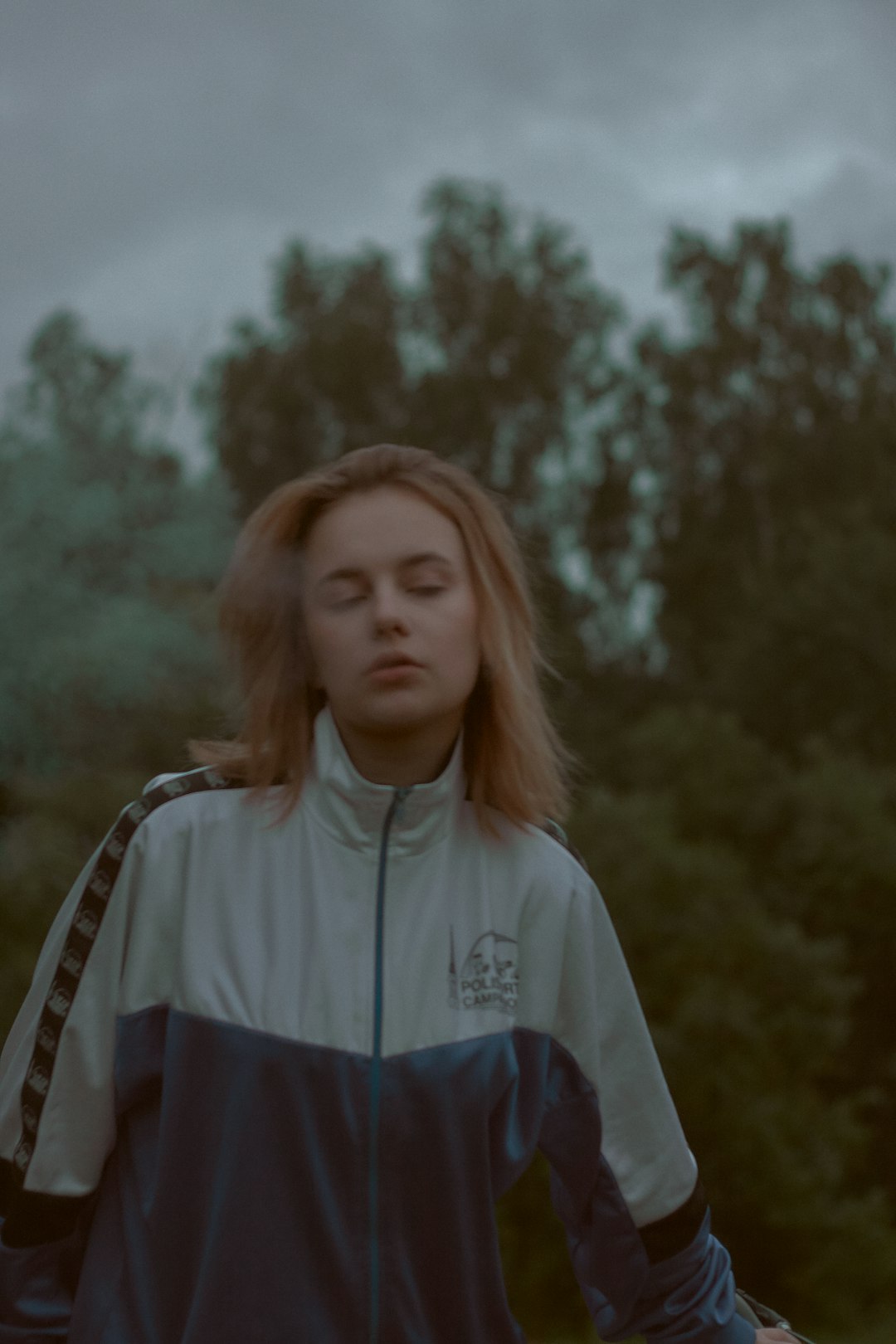 woman wearing white and blue zip-up jacket