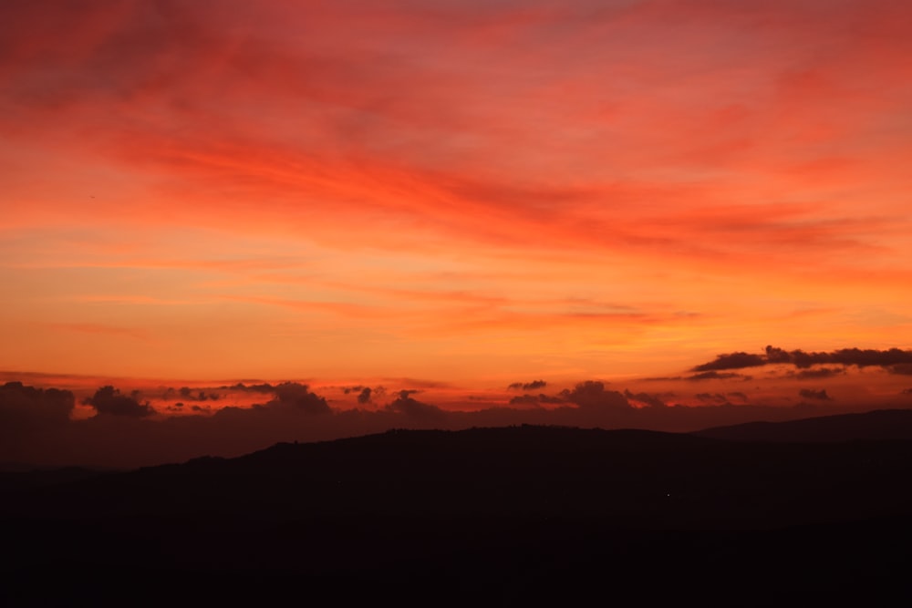 silhouette of hill at sunset