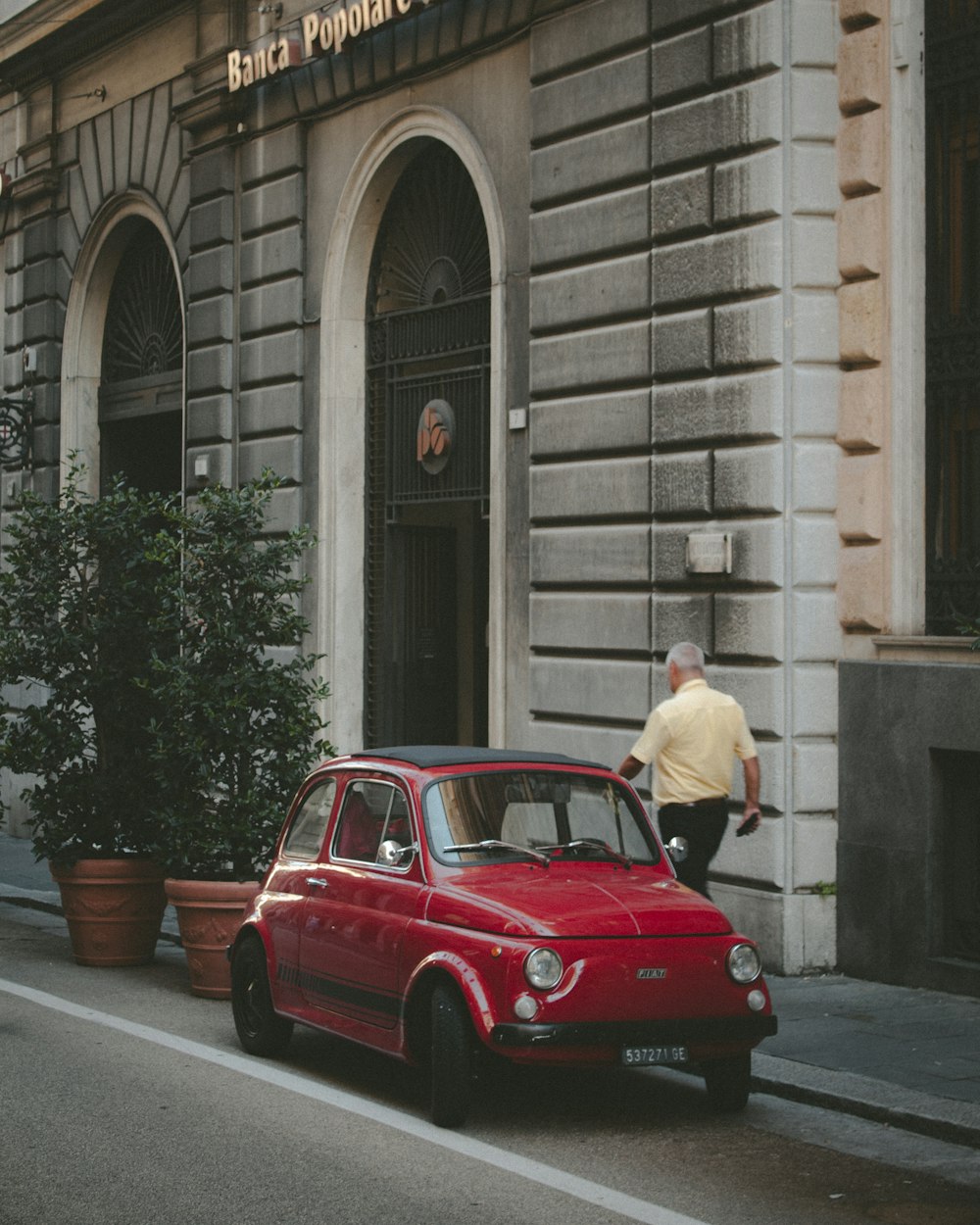 red 3-door hatchback parked on the street