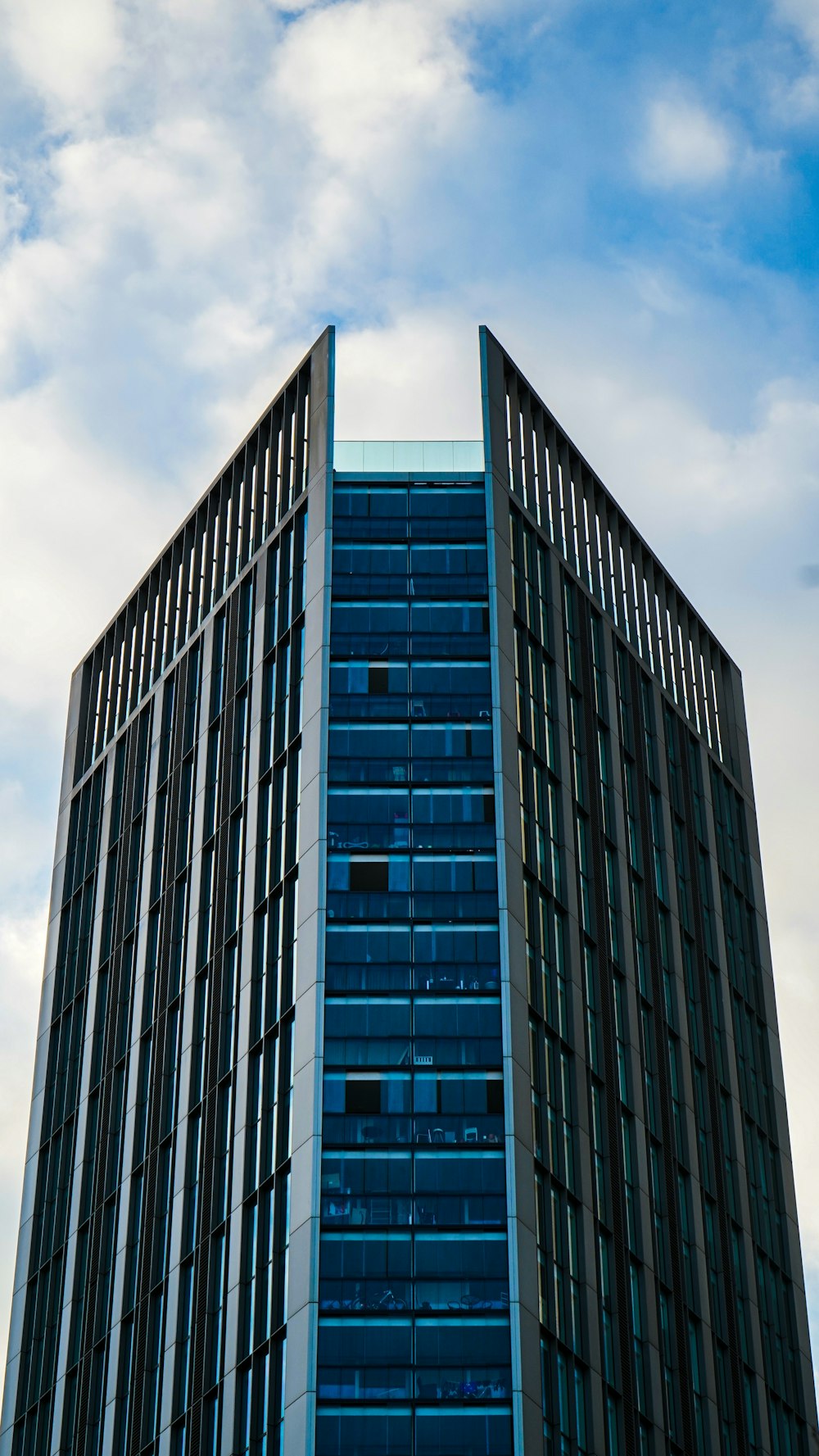 blue and gray building with glass curtain