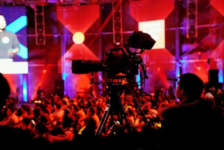 man standing beside video camera