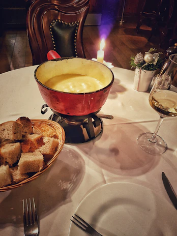 Close-up of a bubbling local cheese fondue served in a traditional pot.