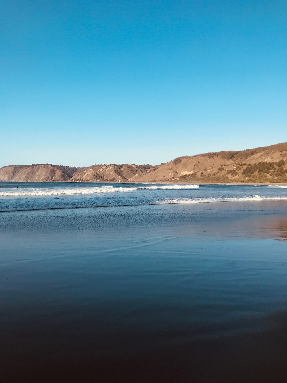 sea waves crashing on shoreline