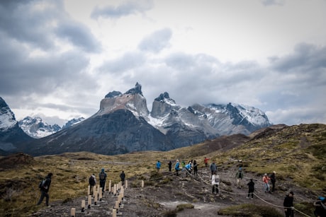 Torres del Paine - Hikers on the trail with the Cuernos peaks ahead