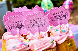 Pink birthday cupcakes with custom Happy Birthday toppers