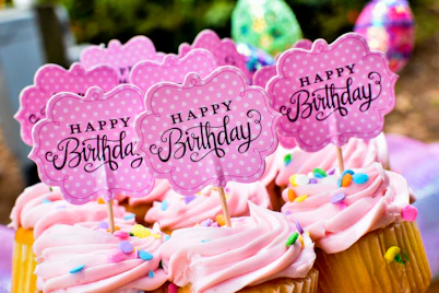 Pink birthday cupcakes with custom Happy Birthday toppers