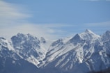 The majestic snow-capped peaks of Ladakh under a clear blue sky.