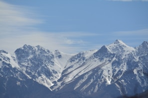 The majestic mountains of Himachal Pradesh under a clear blue sky.