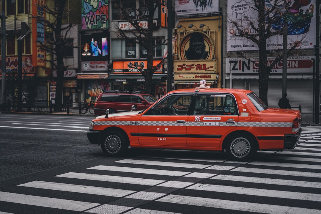 red taxi on pedestrian lane