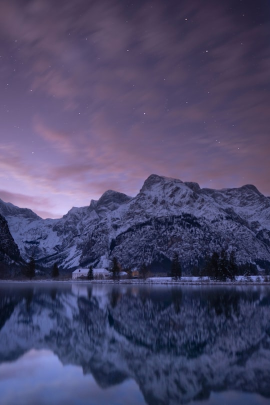 lake with hills on side in Almsee Austria