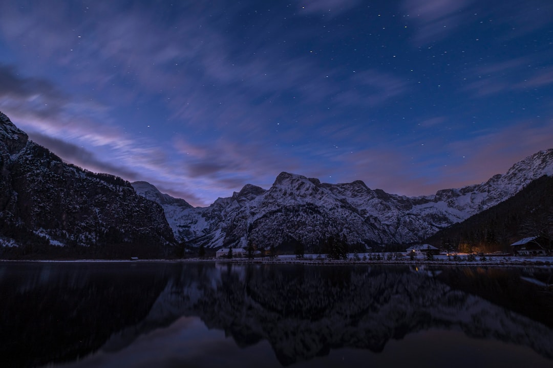 snow-covered mountain reflected on calm body of water