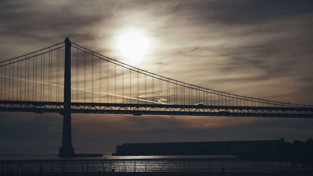 silhouette photography of suspension bridge